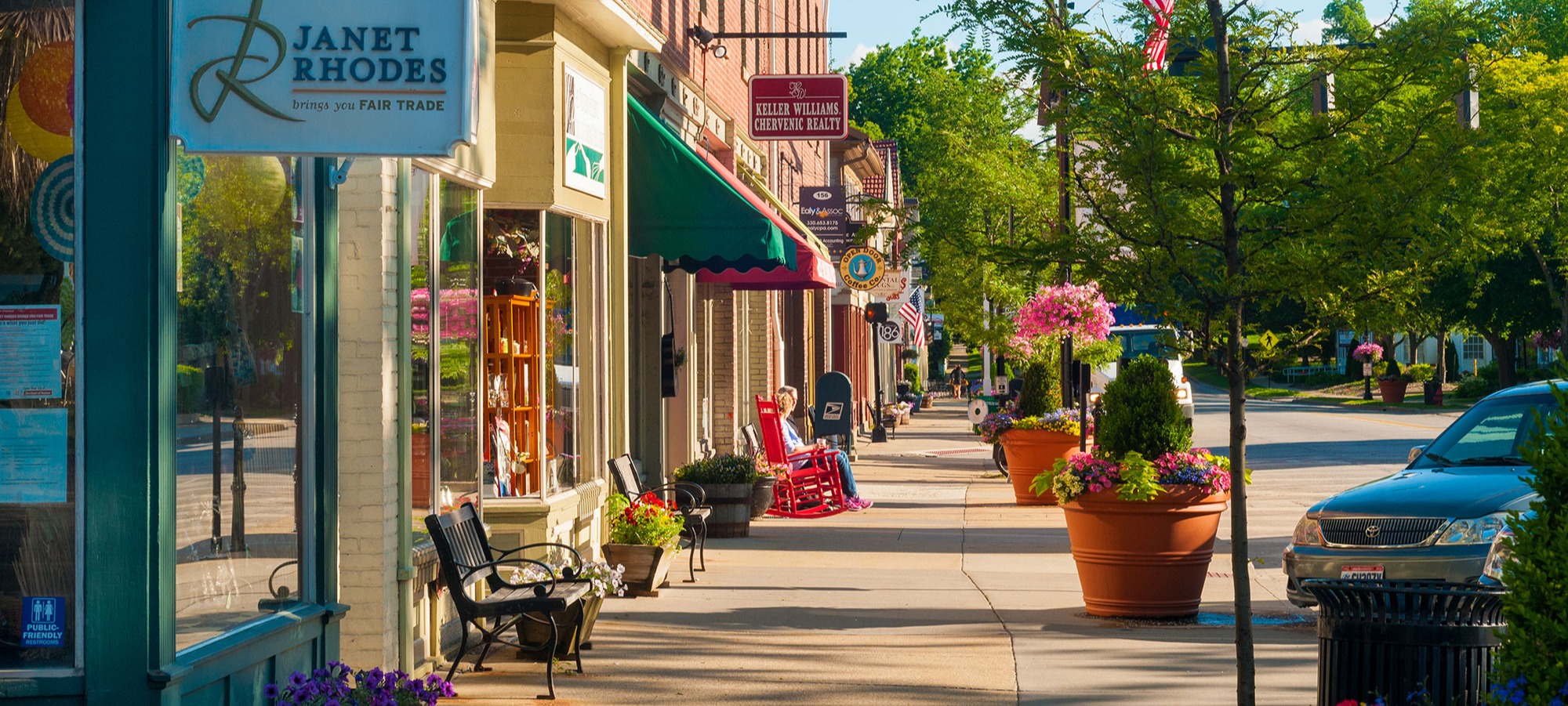 Sidewalk view of various business in a small town.